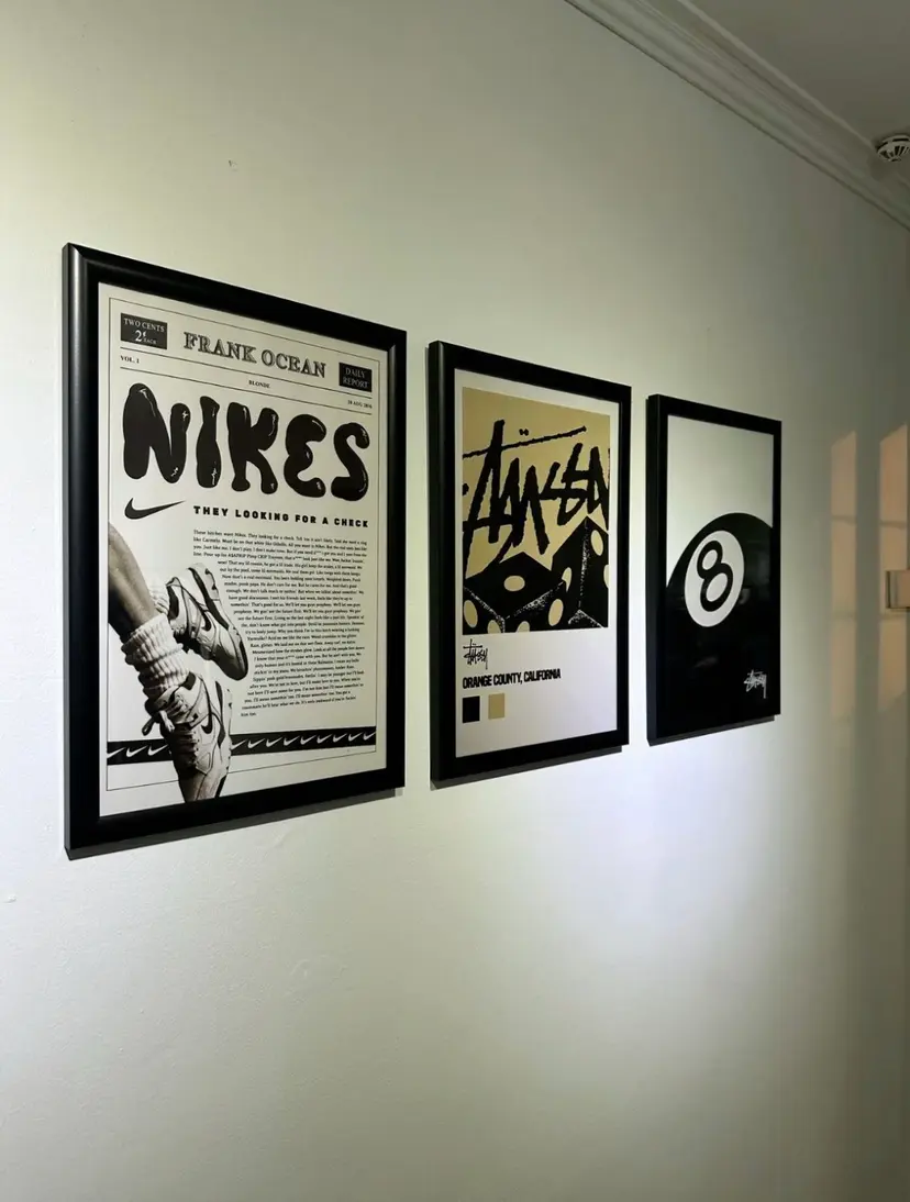 Three black-framed POSTERIZE posters hung in a row on a pale wall